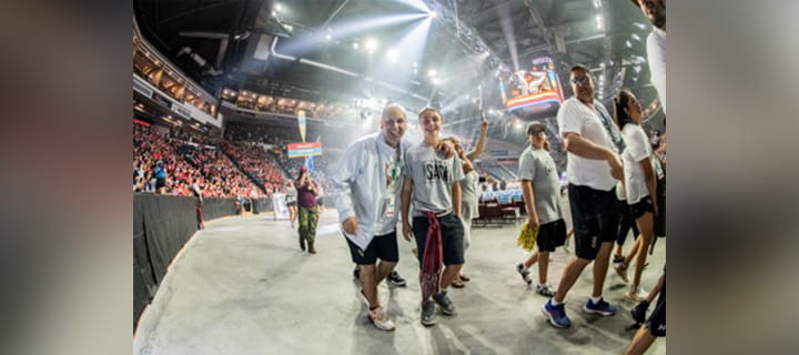 Man and woman posing in a large arena